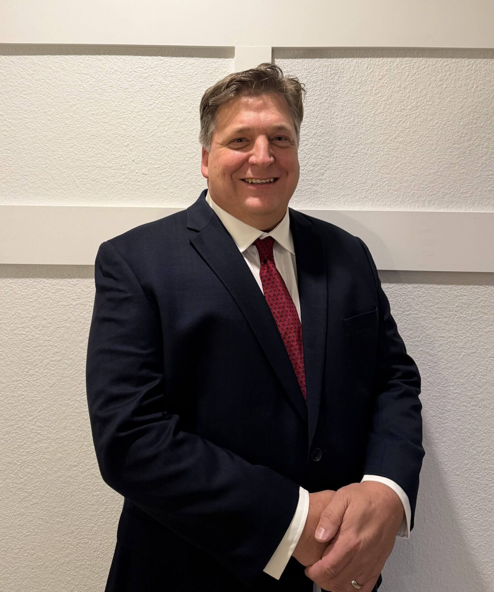 Mike Kunkel, in a white collared shirt and a blue sport coat